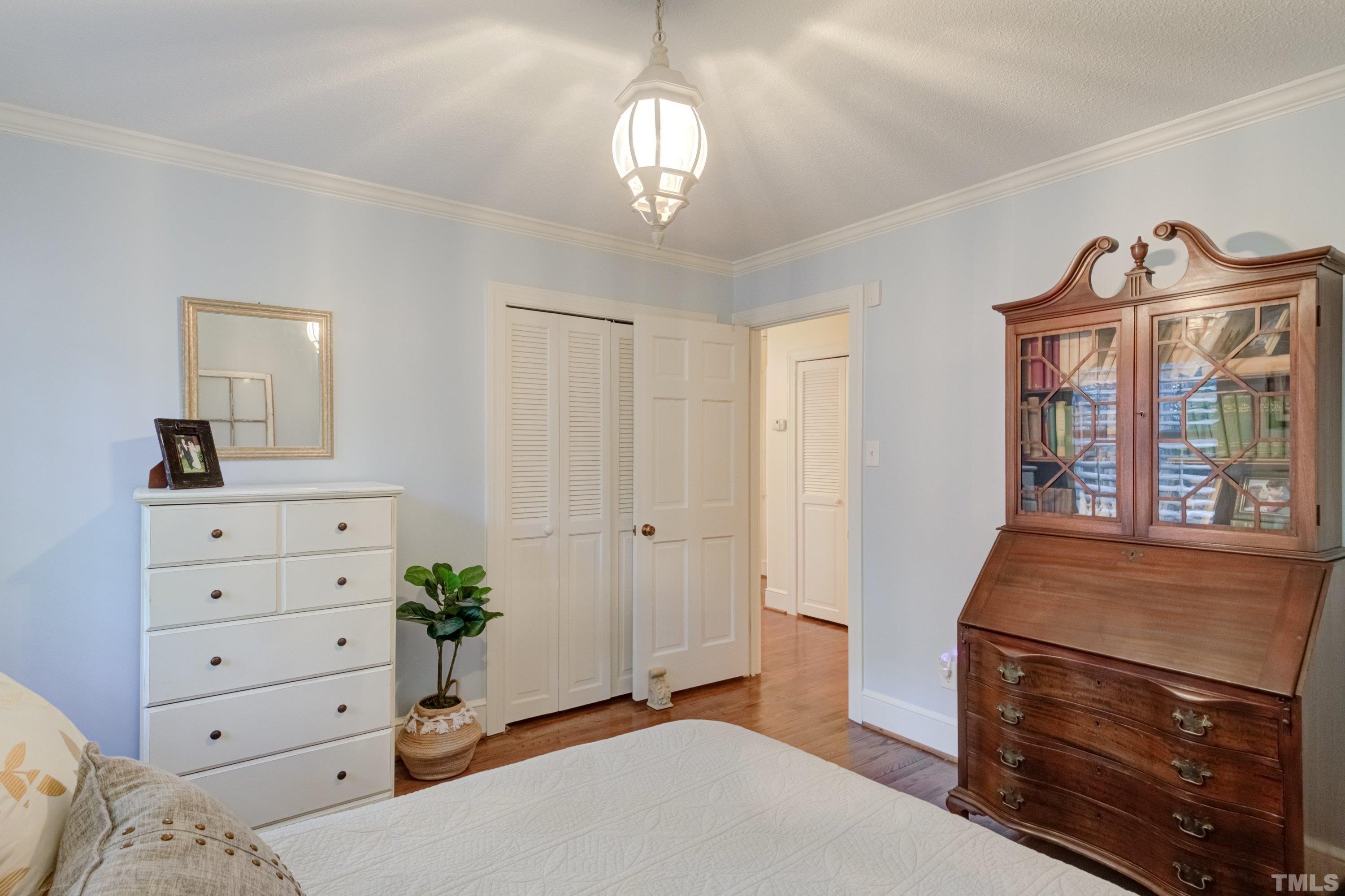 1109 Country Ridge Drive Raleigh, NC 27609 - Photo 35 of 64 a bedroom with a bed and a dresser