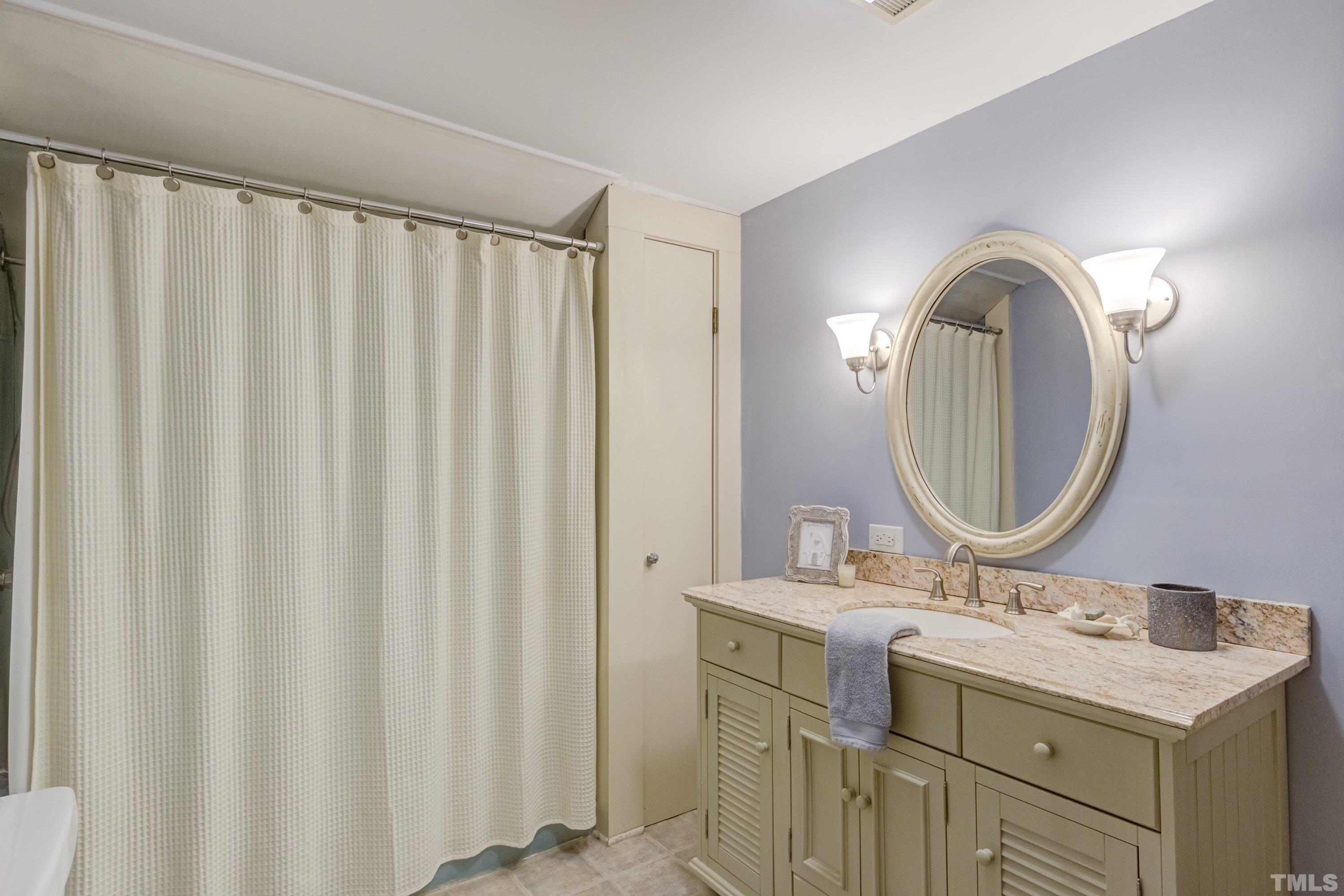1109 Country Ridge Drive Raleigh, NC 27609 - Photo 44 of 64 a bathroom with a sink and a mirror
