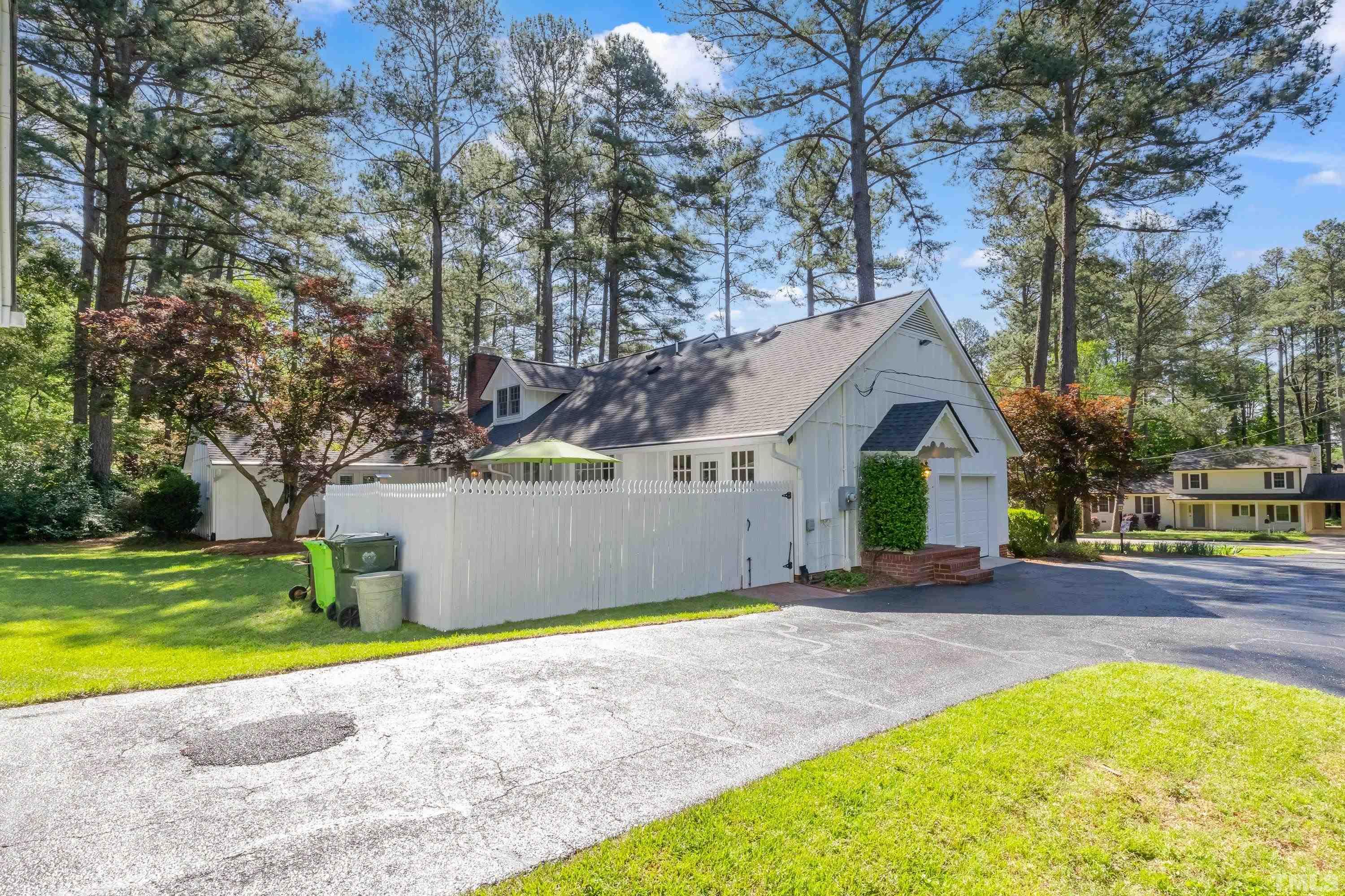 1109 Country Ridge Drive Raleigh, NC 27609 - Photo 52 of 64 a front view of a house with a yard and swimming pool