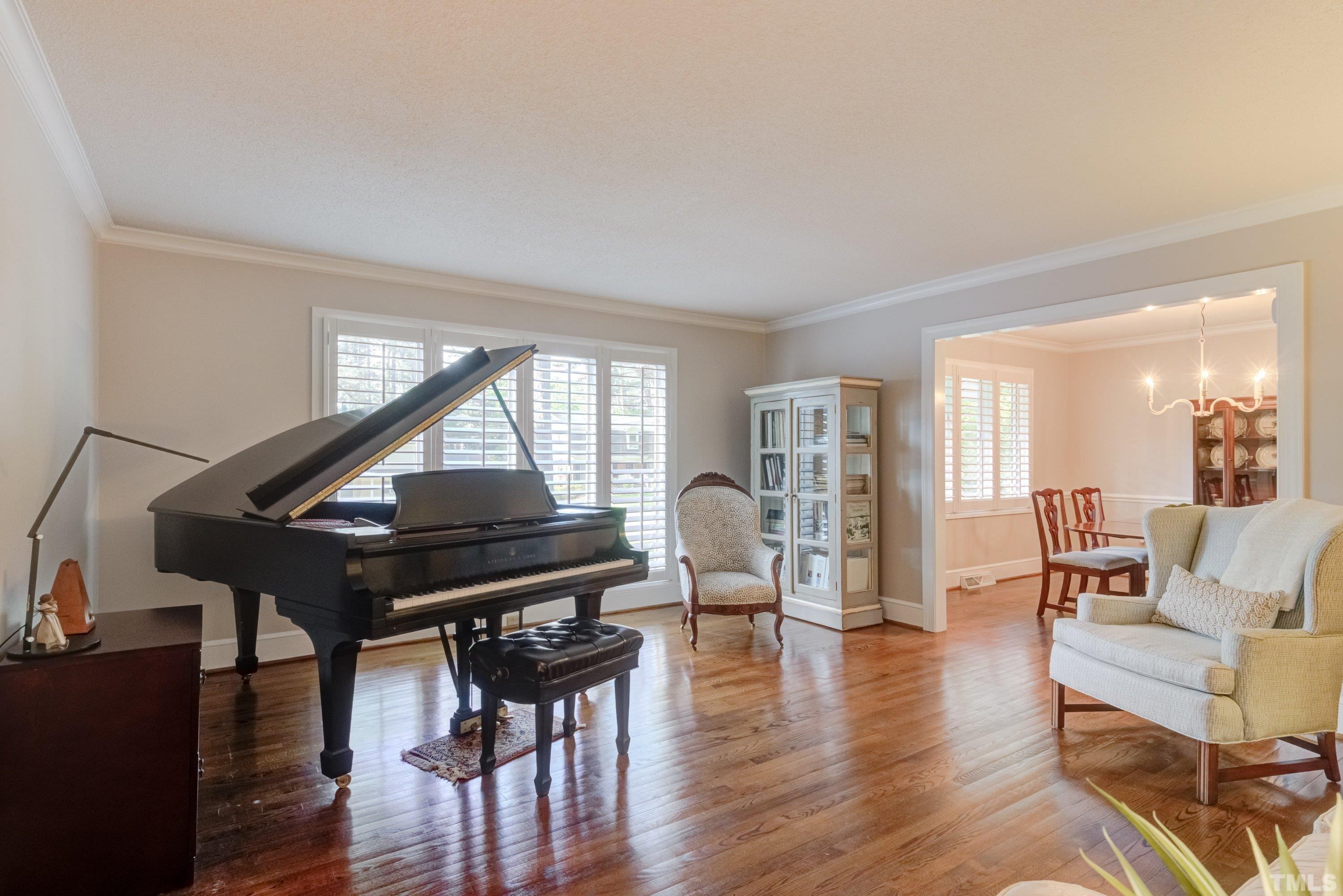 1109 Country Ridge Drive Raleigh, NC 27609 - Photo 7 of 64 a living room with furniture a wooden floor and a piano