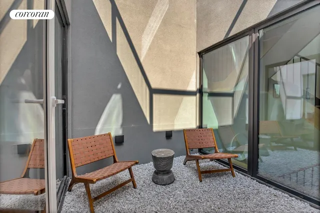 a living room with furniture lamp and a large window