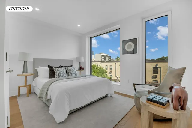 a roof deck with couches and sky view