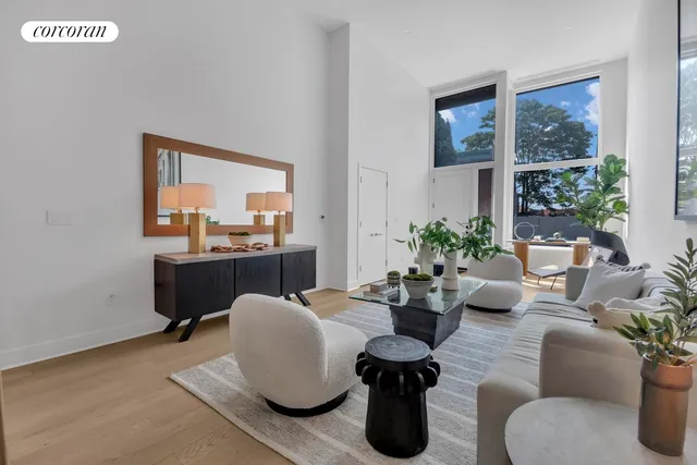 a living room with furniture and flowers