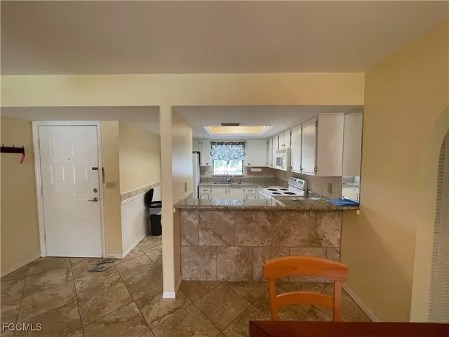 a bathroom with a granite countertop sink a mirror and shower