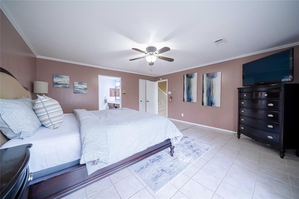 919 Green Hills Road Duncanville, TX 75137 - Photo 18 of 37 Bedroom with ornamental molding, light tile patterned floors, baseboards, ceiling fan, and connected bathroom