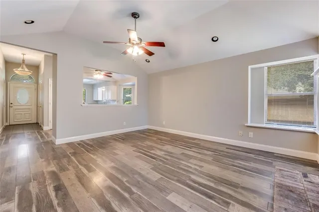 wooden floor in an empty room with a window