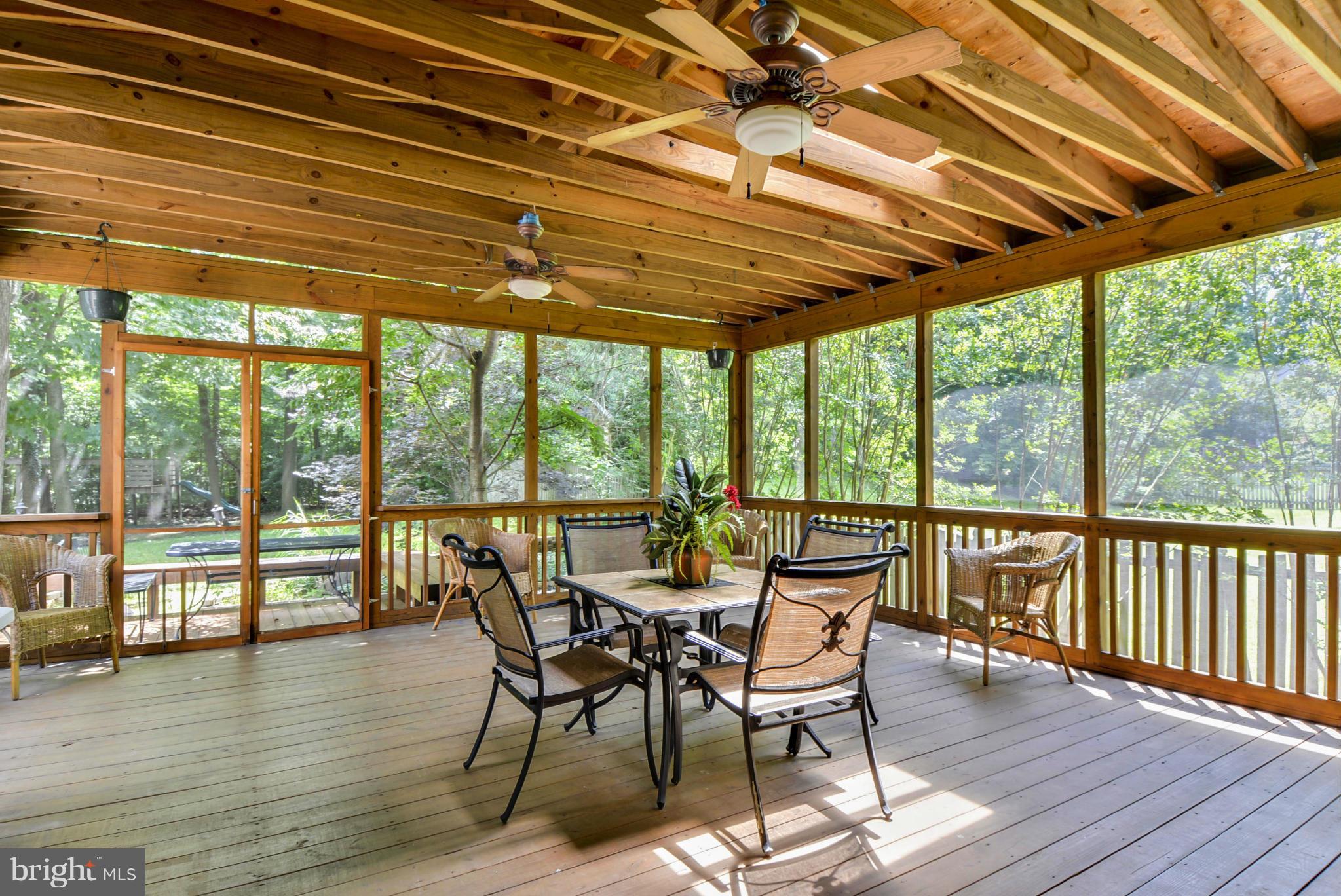 15509 Overchase Lane Bowie, MD 20715 - Photo 11 of 30 a view of a patio with table and chairs and wooden floor