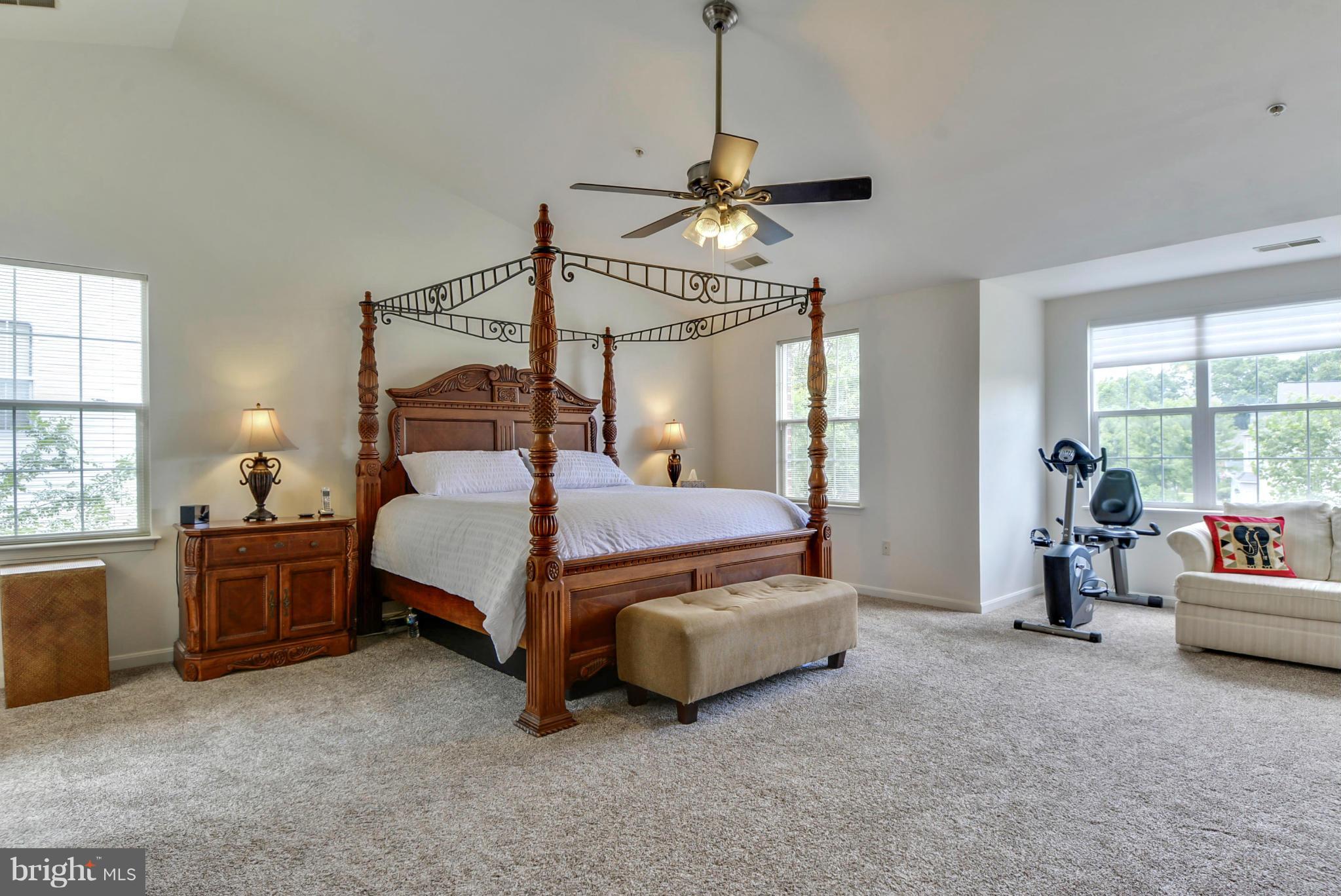 15509 Overchase Lane Bowie, MD 20715 - Photo 13 of 30 a bedroom with a bed and a chandelier