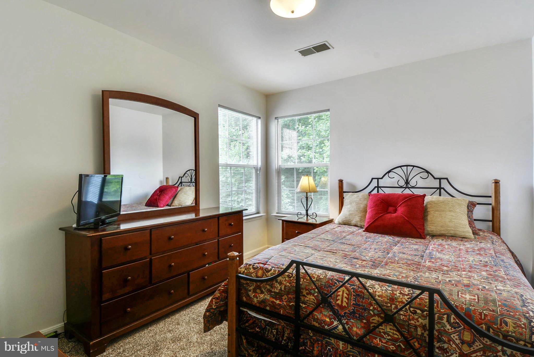 15509 Overchase Lane Bowie, MD 20715 - Photo 17 of 30 a bedroom with a bed and a dresser