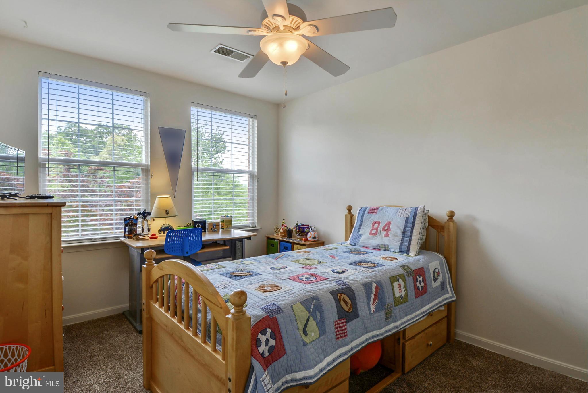15509 Overchase Lane Bowie, MD 20715 - Photo 18 of 30 a bedroom with a bed and a chandelier