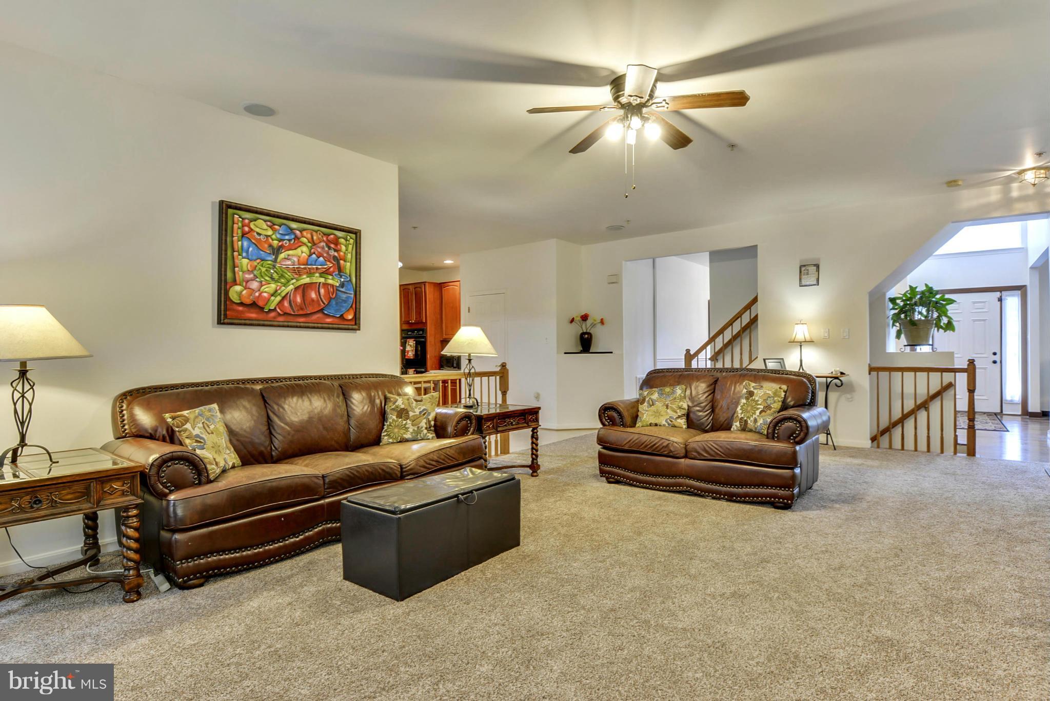 15509 Overchase Lane Bowie, MD 20715 - Photo 7 of 30 a living room with furniture and a chandelier