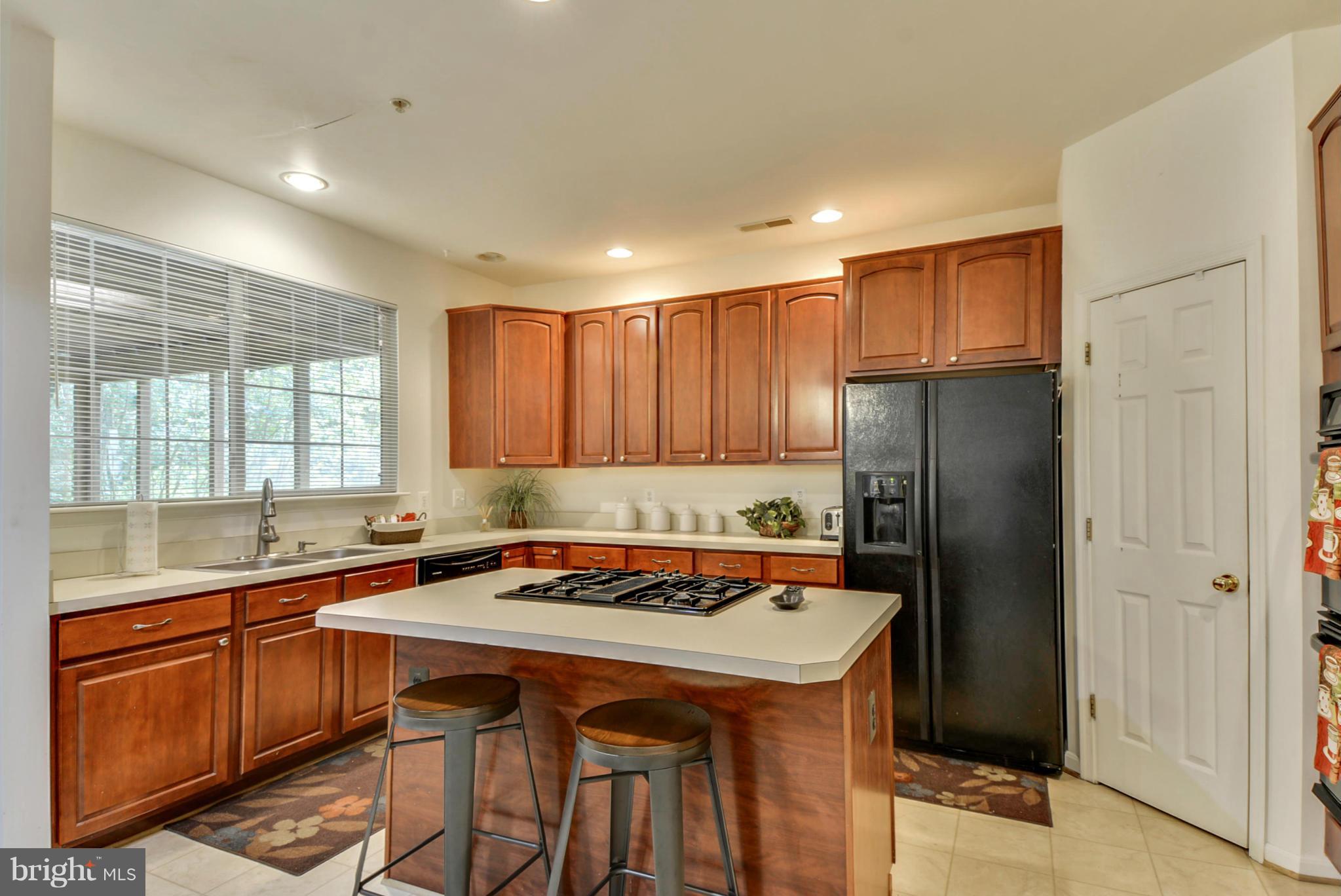 15509 Overchase Lane Bowie, MD 20715 - Photo 8 of 30 a kitchen with a refrigerator a sink a stove and cabinets