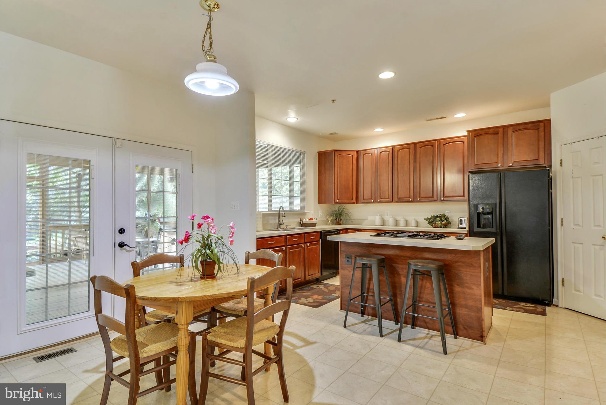 15509 Overchase Lane Bowie, MD 20715 - Photo 10 of 30 a kitchen with a table and chairs in it