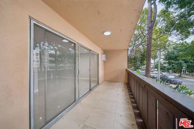 a balcony with view of outdoor space