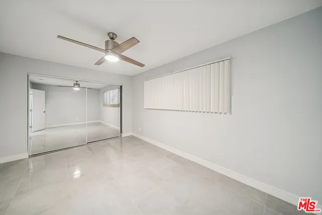 an empty room with a empty space and windows