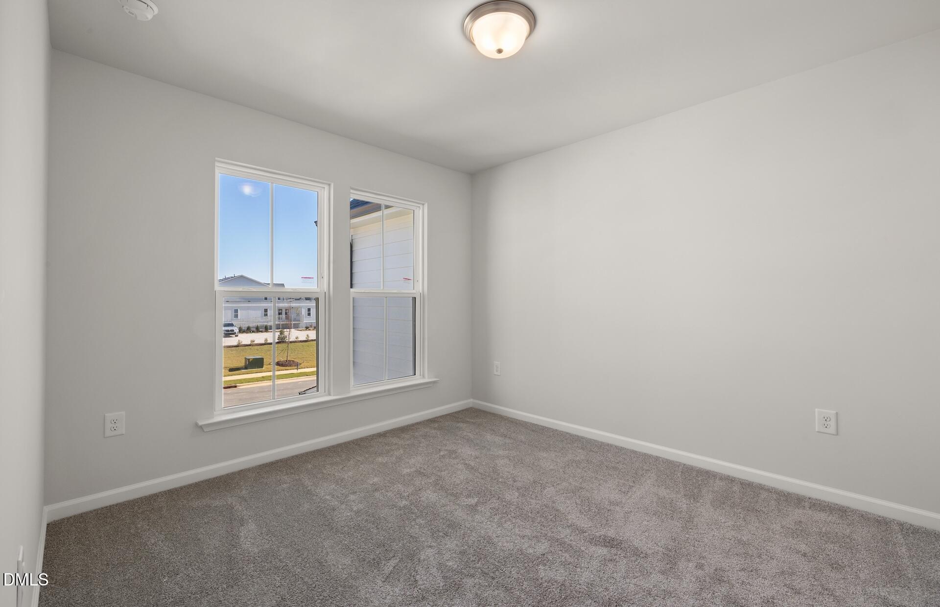 2822 Rodeo Court Fuquay-Varina, NC 27526 - Photo 21 of 30 an empty room with windows and refrigerator