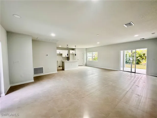 a view of empty room with a fireplace