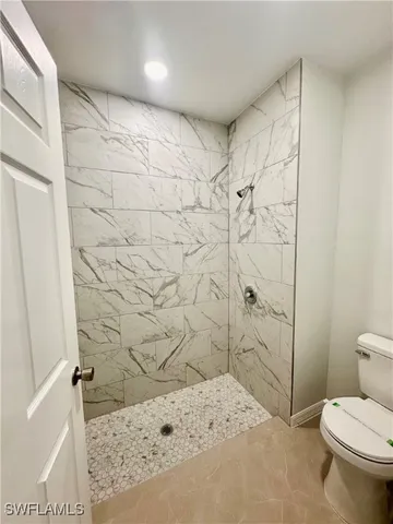a bathroom with a toilet and shower