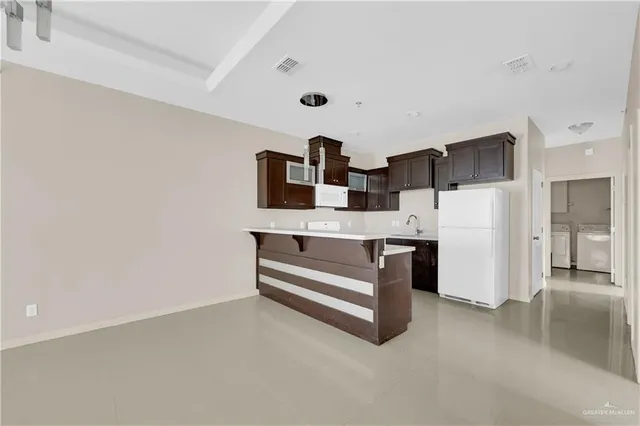 a kitchen with stainless steel appliances a refrigerator and cabinets