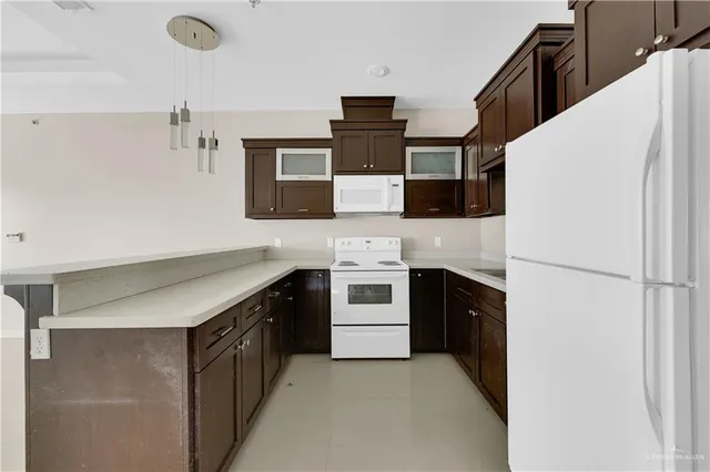 a kitchen with stainless steel appliances a refrigerator sink and stove
