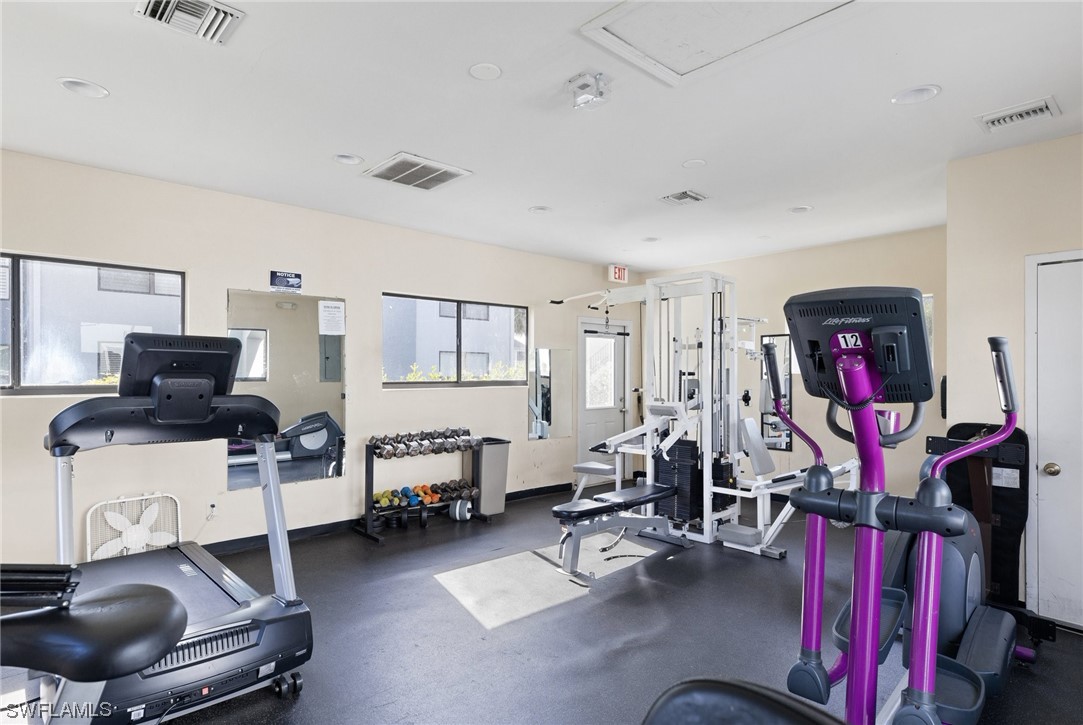 13571 Eagle Ridge Drive, Unit 1325 Fort Myers, FL 33912 - Photo 18 of 26 a room with furniture and a flat screen tv