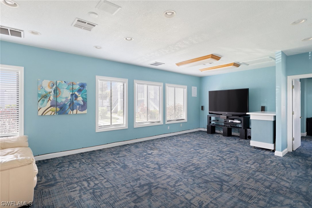 13571 Eagle Ridge Drive, Unit 1325 Fort Myers, FL 33912 - Photo 19 of 26 a living room with furniture and a flat screen tv