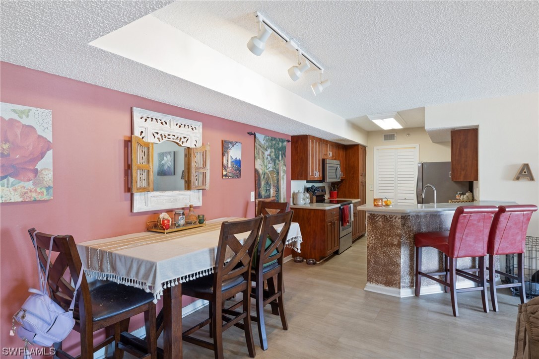 13571 Eagle Ridge Drive, Unit 1325 Fort Myers, FL 33912 - Photo 3 of 26 a view of a dining room with furniture