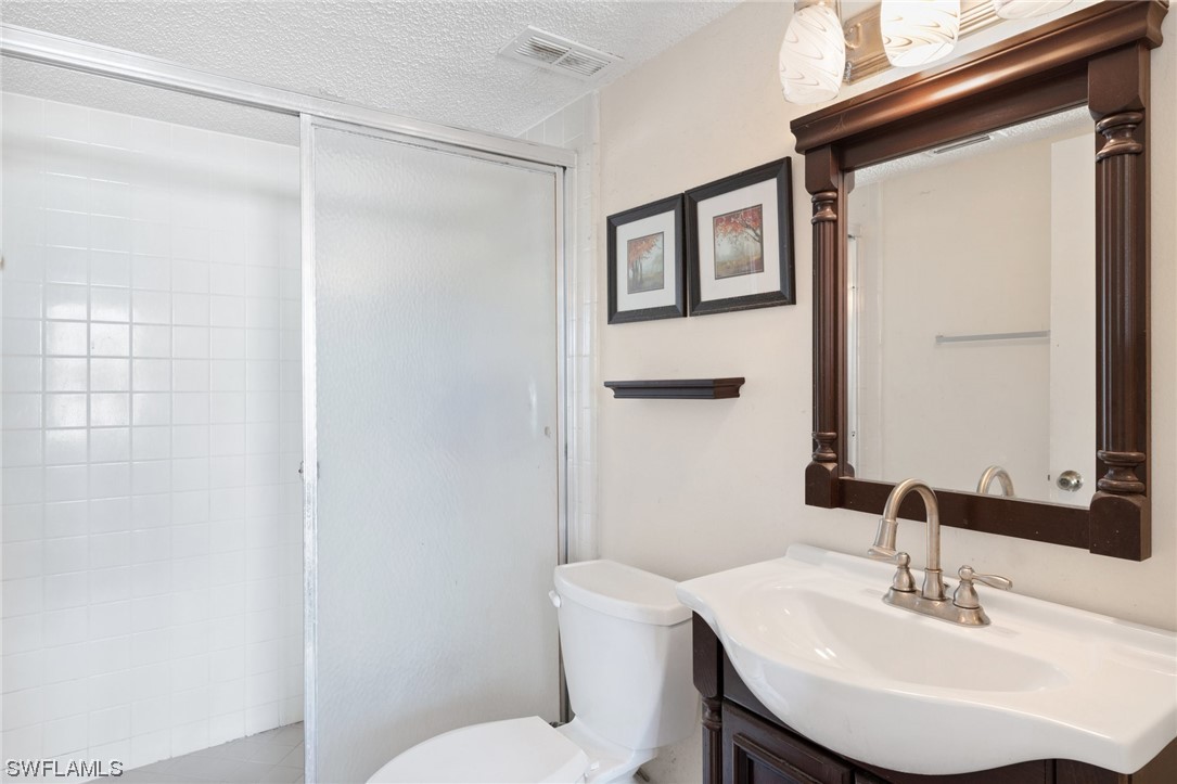 13571 Eagle Ridge Drive, Unit 1325 Fort Myers, FL 33912 - Photo 6 of 26 a bathroom with a sink toilet and vanity