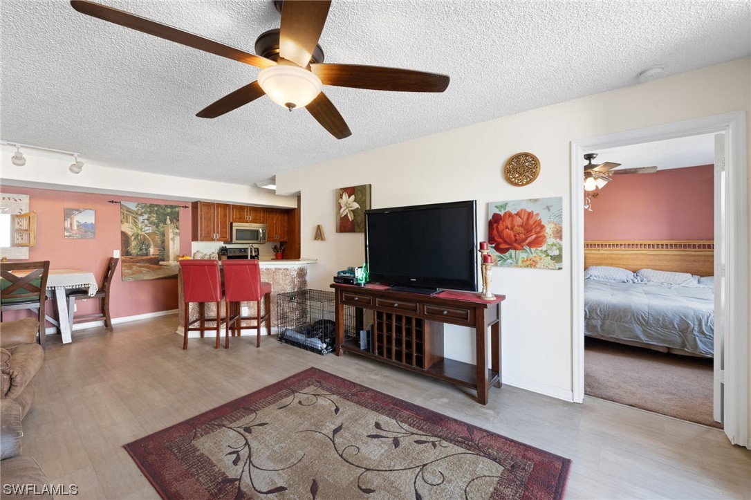 13571 Eagle Ridge Drive, Unit 1325 Fort Myers, FL 33912 - Photo 8 of 26 a living room with furniture and a flat screen tv