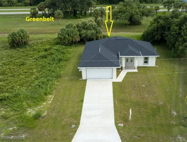 a aerial view of a house with a yard