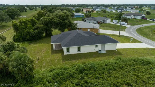 an aerial view of a house with a yard
