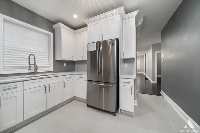 a kitchen with stainless steel appliances granite countertop a refrigerator and a sink