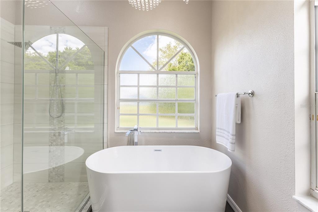 12230 Padron Boulevard Spring Hill, FL 34609 - Photo 11 of 22 a white bath tub sitting in a bathroom next to a window