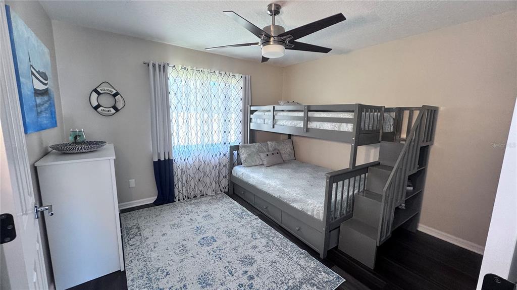 12230 Padron Boulevard Spring Hill, FL 34609 - Photo 13 of 22 a bedroom with a bed and a window