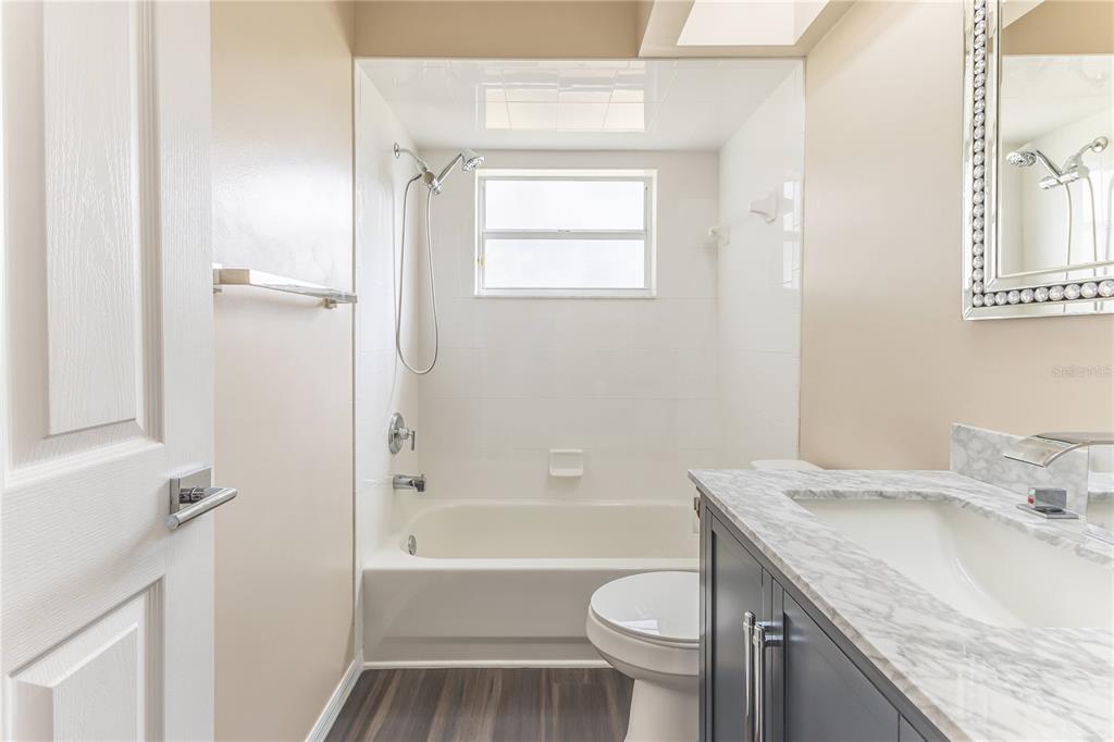 12230 Padron Boulevard Spring Hill, FL 34609 - Photo 14 of 22 a bathroom with a granite countertop sink toilet and shower