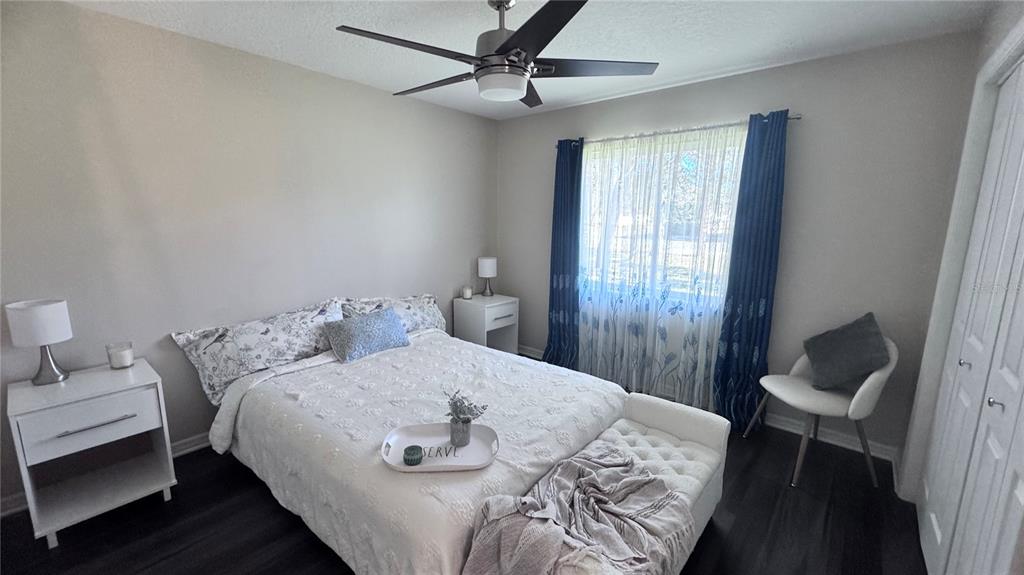 12230 Padron Boulevard Spring Hill, FL 34609 - Photo 15 of 22 a bedroom with a bed and a chair