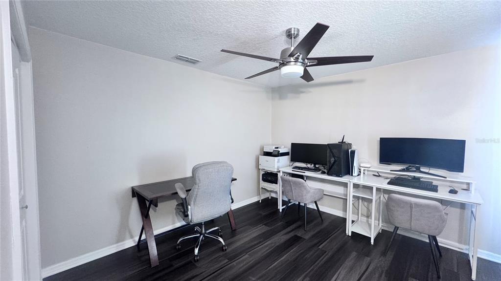 12230 Padron Boulevard Spring Hill, FL 34609 - Photo 16 of 22 a view of a workspace with furniture and wooden floor