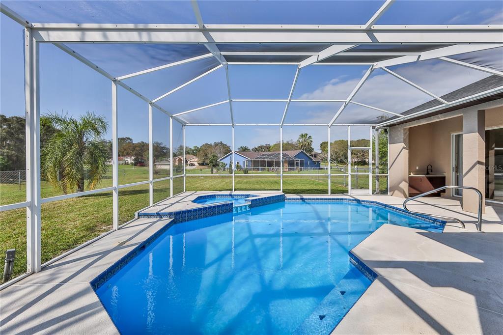 12230 Padron Boulevard Spring Hill, FL 34609 - Photo 20 of 22 a view of a room with wooden floor and iron fence