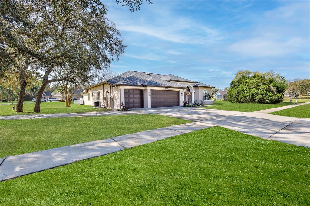 12230 Padron Boulevard Spring Hill, FL 34609 - Photo 4 of 22 a front view of house with yard and green space