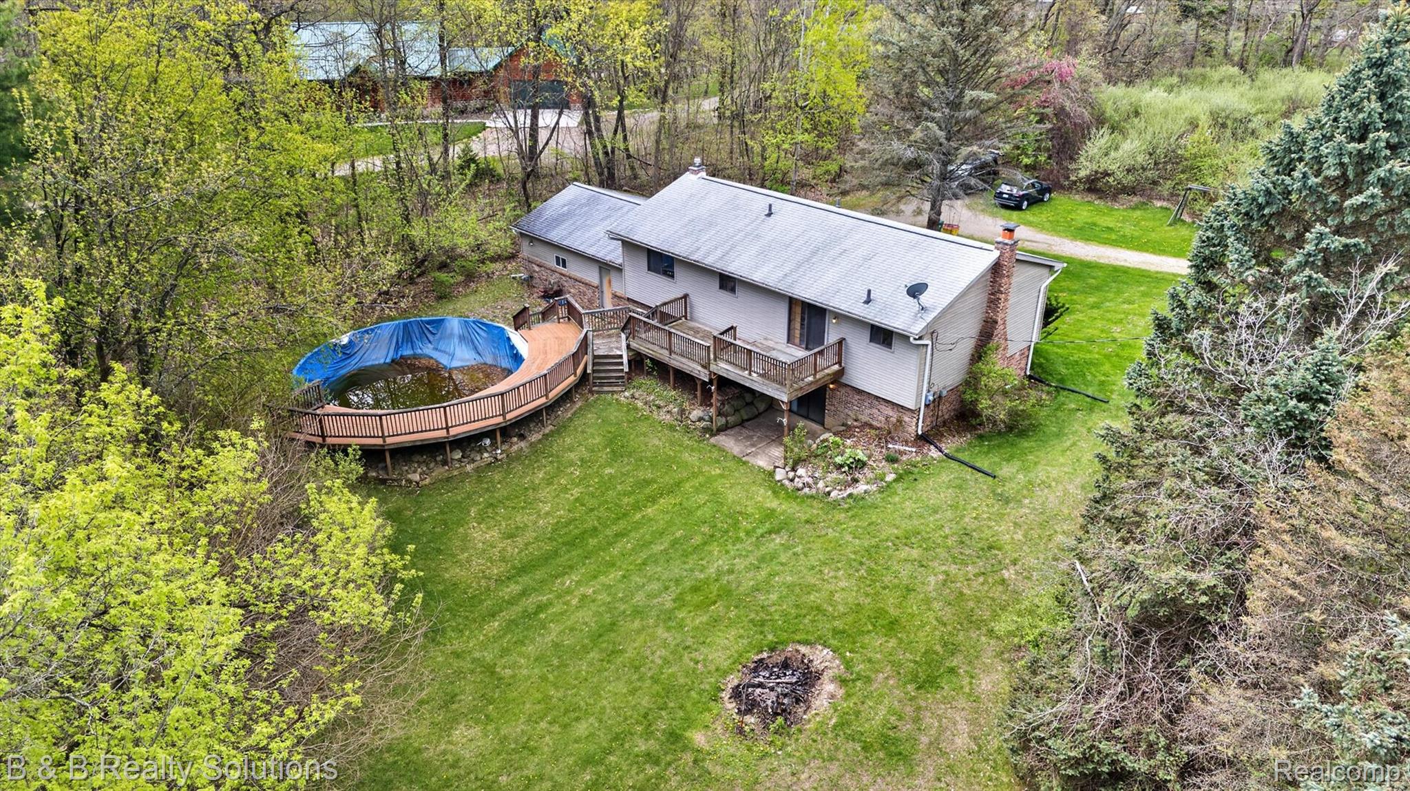 2467 North Lake George Road Metamora, MI 48455 - Photo 39 of 46 Aerial view of property and surrounding area with a tree filled landscape