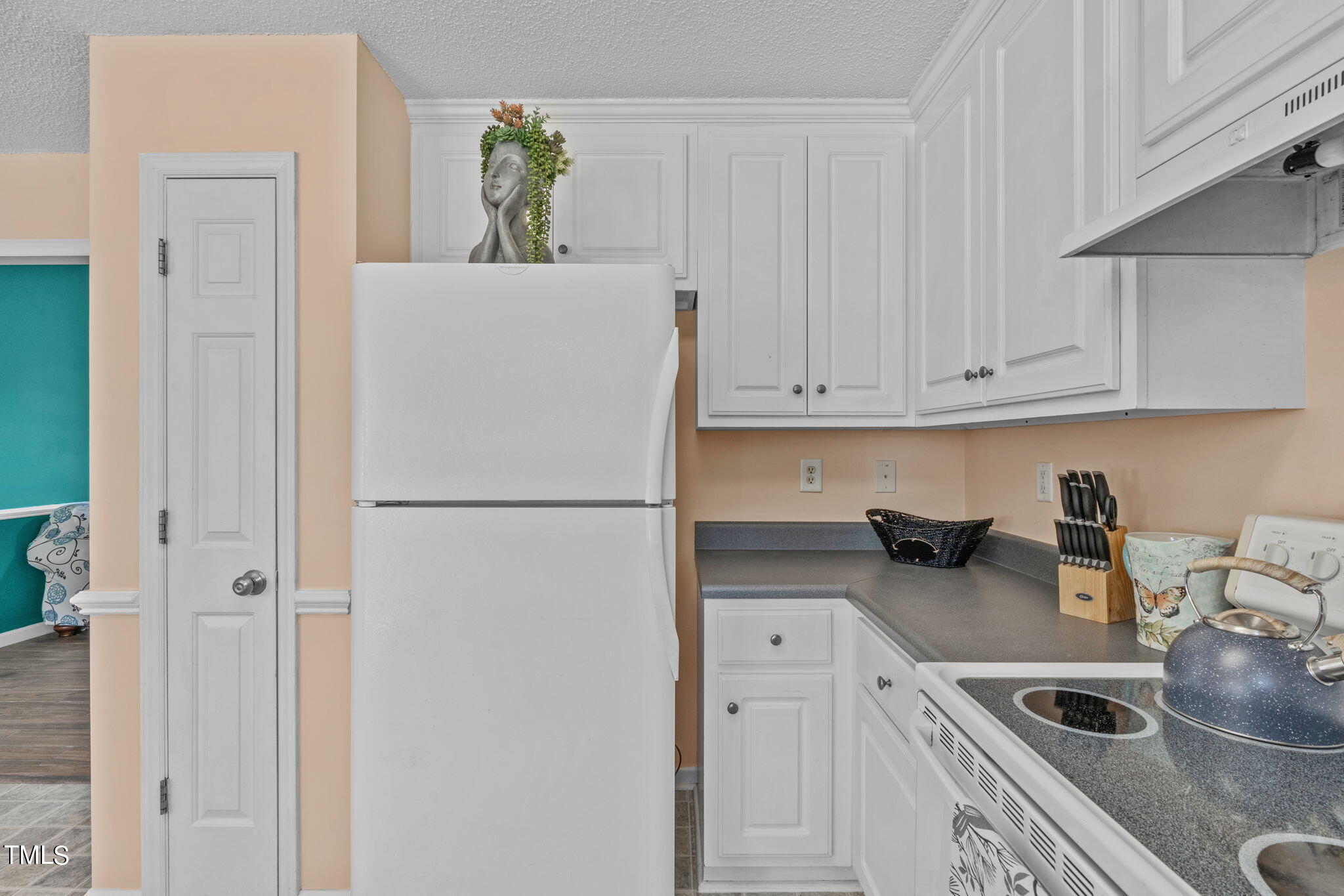 128 Edmondson Drive Willow Spring, NC 27592 - Photo 11 of 38 a kitchen with a refrigerator a stove a sink and cabinets