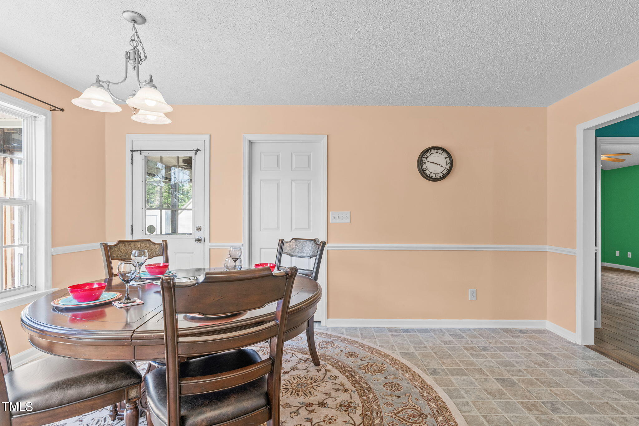 128 Edmondson Drive Willow Spring, NC 27592 - Photo 12 of 38 a view of a dining room with furniture and a chandelier