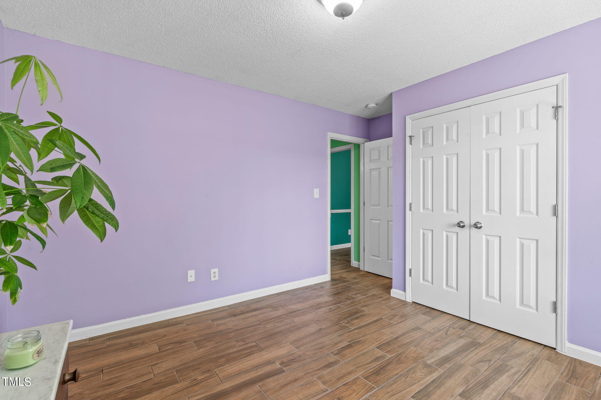 128 Edmondson Drive Willow Spring, NC 27592 - Photo 14 of 38 a view of an empty room with wooden floor and a window