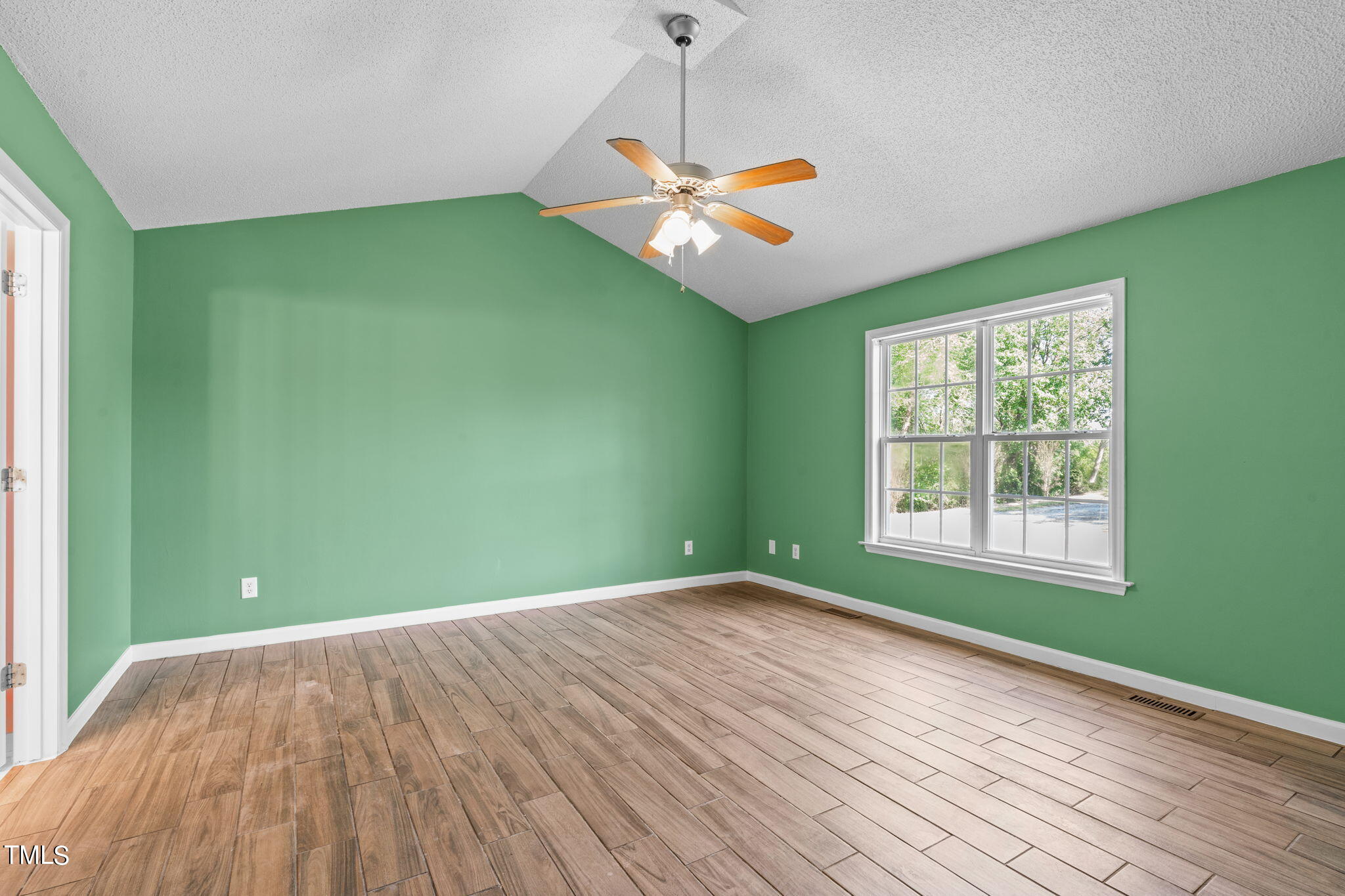128 Edmondson Drive Willow Spring, NC 27592 - Photo 17 of 38 a view of a room with a window and wooden floor
