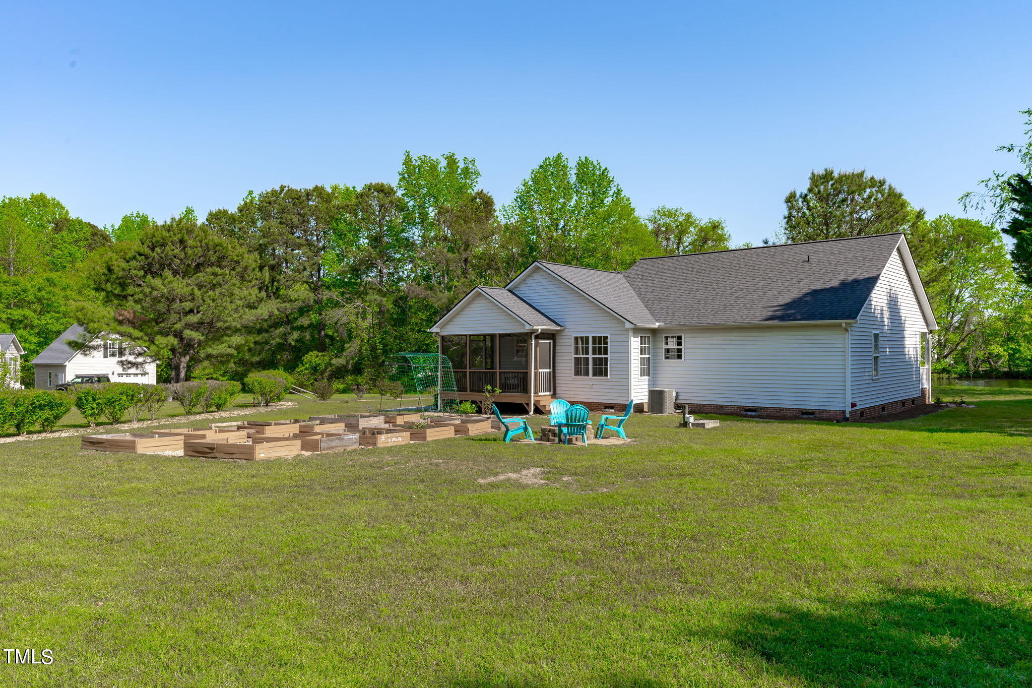 128 Edmondson Drive Willow Spring, NC 27592 - Photo 30 of 38 a backyard of a house with table and chairs