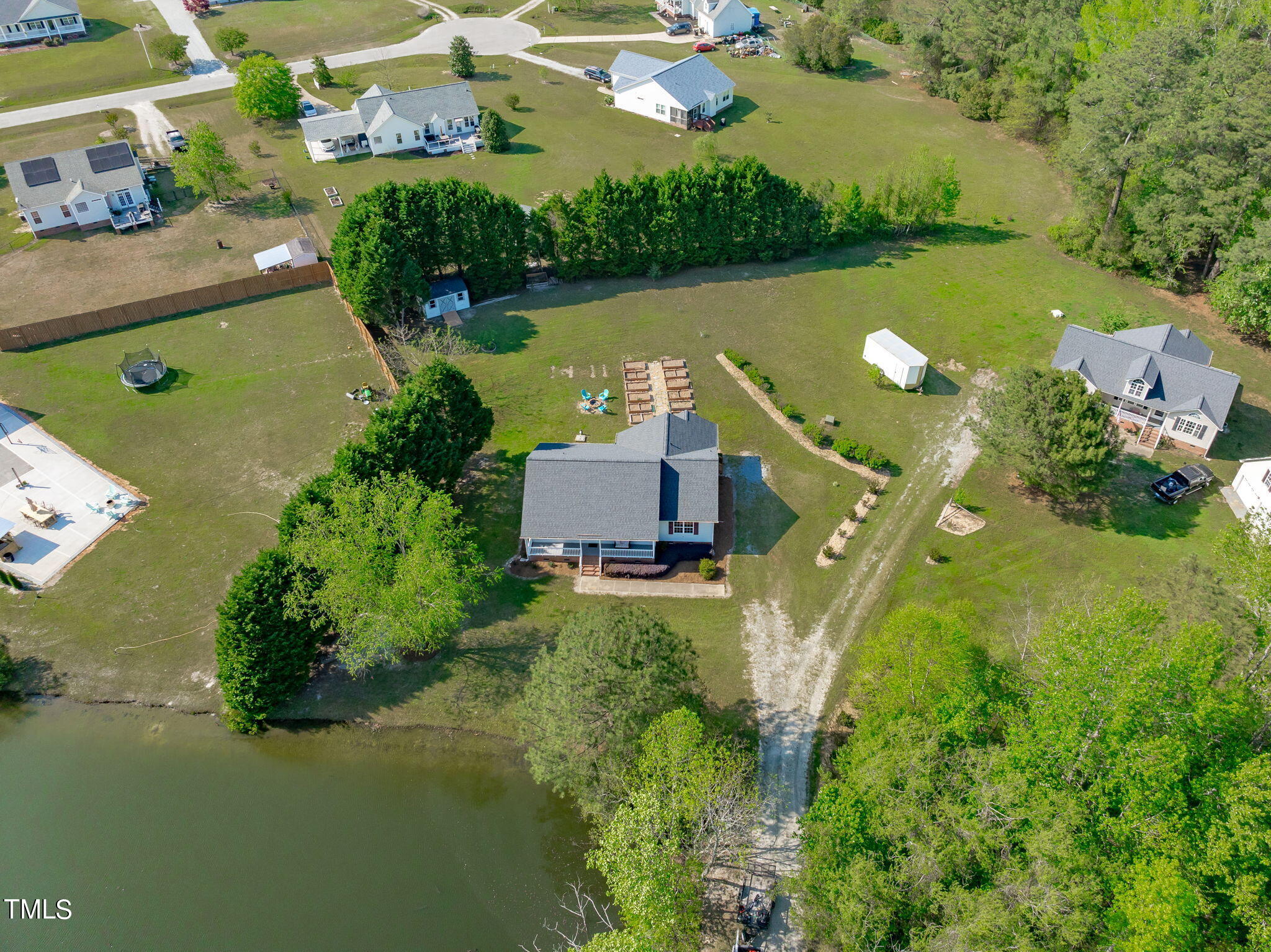 128 Edmondson Drive Willow Spring, NC 27592 - Photo 36 of 38 an aerial view of a house with a garden and lake view
