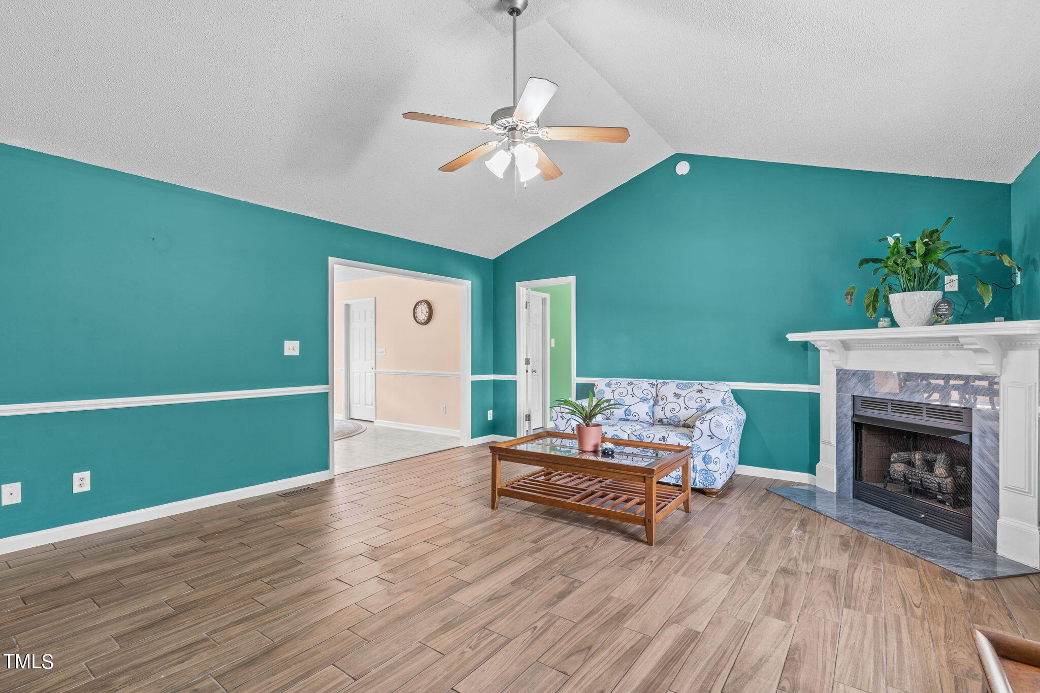 128 Edmondson Drive Willow Spring, NC 27592 - Photo 4 of 38 a living room with furniture and a fireplace
