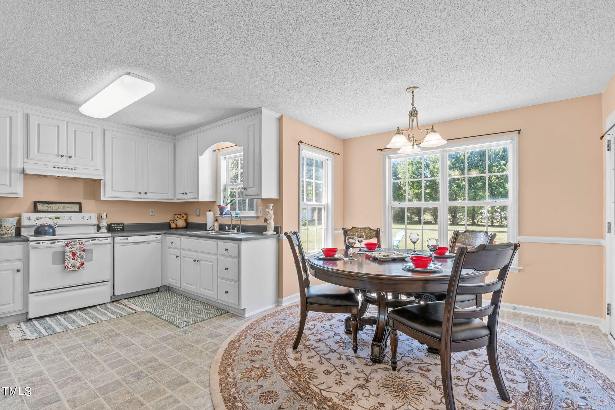 128 Edmondson Drive Willow Spring, NC 27592 - Photo 8 of 38 a view of a dining room with furniture and windows