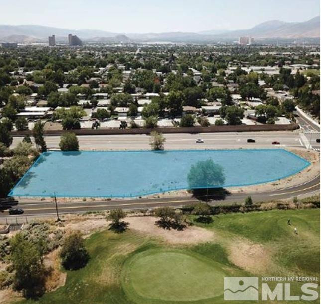 an aerial view of residential houses with outdoor space and swimming pool