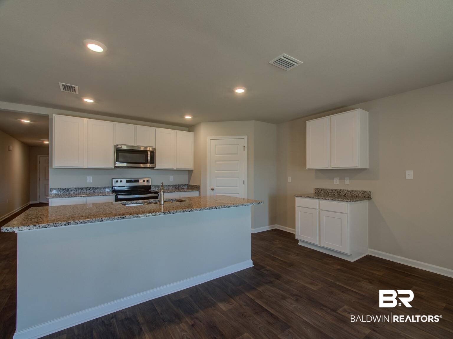 23953 Citation Loop Daphne, AL 36526 - Photo 11 of 49 Kitchen with white cabinetry, stainless steel appliances, dark stone counters, recessed lighting, and dark wood-style floors